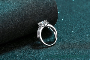 Macro detail of a 2ct moissanite ring with six-prong setting and side diamond accents