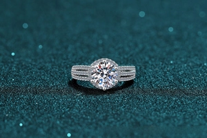 Macro shot of 2 carat Moissanite ring with six-prong setting and halo pavé band