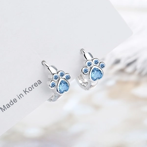 Cute silver earrings with blue zircon in a cat paw print design on white card