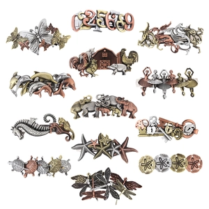 Detail view of 15 vintage steampunk metal hair clips with varied bronze animal and key motifs