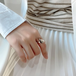 Close-up of irregular liquid metal silver ring with minimalist organic curves for women