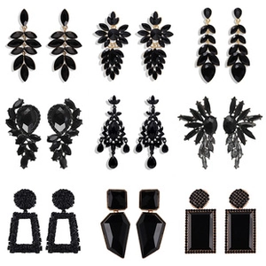Detailed set of nine black dangle earrings featuring tassels and geometric floral designs
