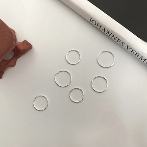 Detailed view of six stackable minimalist 925 silver rings with polished finish