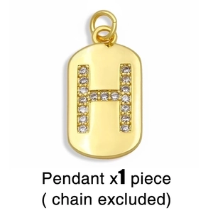 Close-up of golden letter H pendant with rhinestones, showing exquisite metallic details