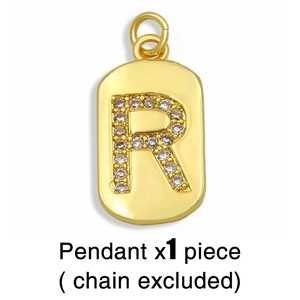 Close-up of gold R letter pendant with zircon inlay on a white background without chain