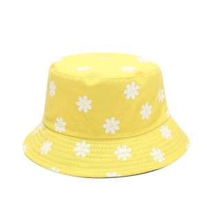 Yellow bucket hat with white daisy floral print made of cotton for sun protection