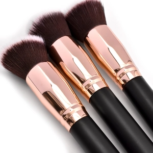 Detail view of trio makeup brushes with rose gold metal ferrules and soft gradient bristles