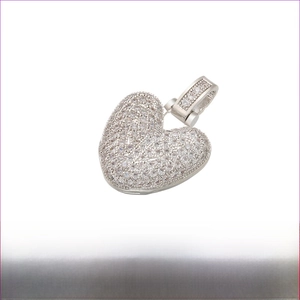 Macro detail of heart pendant with paved clear stones and rhodium plating finish