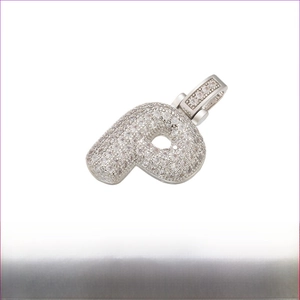 Macro detail of iced-out letter P pendant with dimensions 20mm by 29mm and 5.8g weight