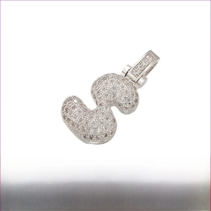Macro detail of Rhodium-plated S-letter pendant with white cubic zirconia and brass base