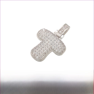Detailed macro view of bubble letter T pendant with iced out stones and dimensions