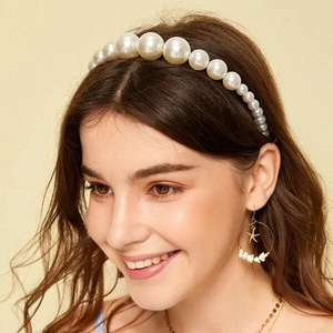 Elegant bridal white pearl headband with starfish earrings set on a female model