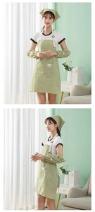 Close-up of green and white striped cotton linen apron with adjustable straps and front pocket
