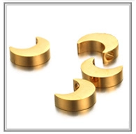 Macro detail of golden crescent moon beads with side holes for DIY jewelry making