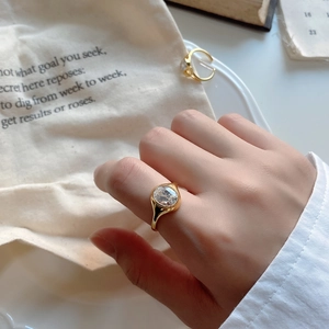 Detailed close-up of a 925 sterling silver gold ring with an oval zircon stone