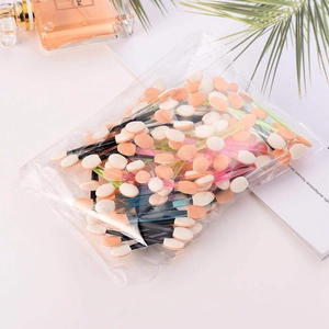 Detailed view of bulk disposable eyeshadow sponge brushes in a transparent poly bag