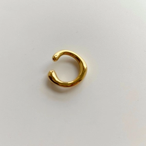 Minimalist gold-plated lava irregular ear cuff with a polished mirror finish on white background