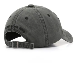Detail view of washed grey baseball cap with New York City embroidery and metal buckle