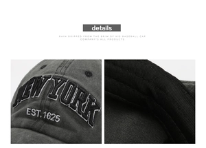 Detail of New York 3D embroidery on washed cotton distressed baseball cap in dark grey