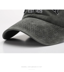 Detail of EST. 1625 embroidery on washed cotton baseball cap with vintage texture