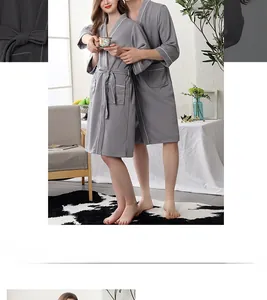 Detailed waffle texture of gray absorbent couple bathrobes with waist tie and pockets