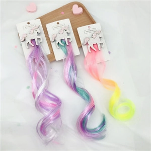 Detailed view of three unicorn glitter hair clips with colorful gradient curly hair pieces