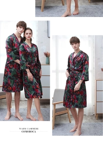 Detail of couple's dark green ice silk bathrobes featuring red abstract floral patterns