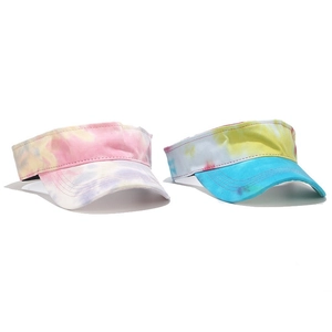 Detail of colorful tie-dye sun visors showing canvas texture and reinforced stitching