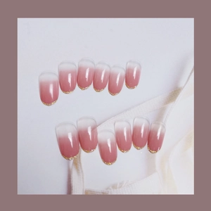Pink ombre press-on nails with golden glitter tips in a set of 12 multi-size pieces