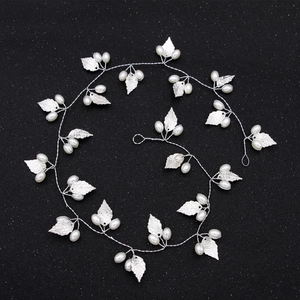 Elegant bridal headband featuring silver alloy leaves and white faux pearls on a flexible vine