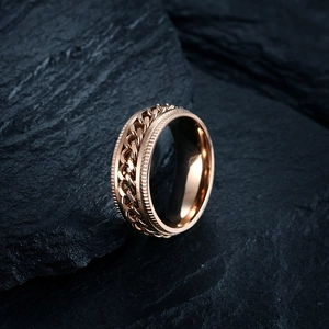 Detailed close-up of a rose gold spinner ring with rotatable Cuban chain and gear edges