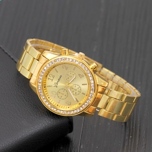 Elegant gold Geneva quartz watch for women with rhinestone bezel on a leather wallet