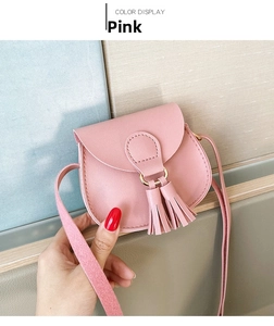Pink mini PU leather crossbody bag featuring dual tassels and a secure flap closure