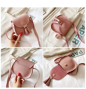 Pink mini crossbody bag for girls featuring tassel detail and magnetic closure