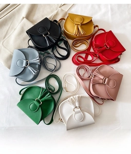Detailed top view of mini crossbody bags with tassels in seven vibrant colors
