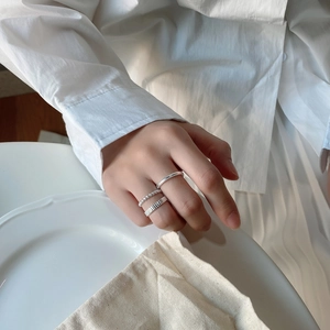 Detailed close-up of 925 sterling silver ring set featuring textured and minimalist bands