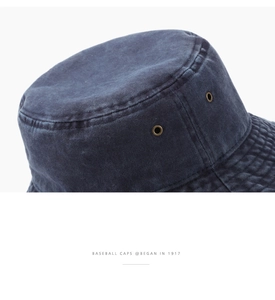 Detail of navy blue washed cotton bucket hat showing vintage metal eyelets and stitching