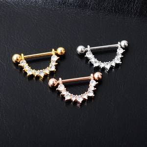 Detailed view of U-shaped nipple rings in gold, silver, and rose gold with zircon inlay