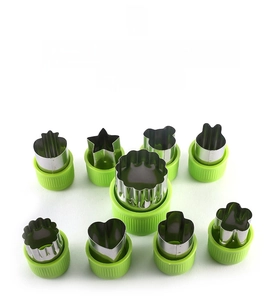 9-piece stainless steel vegetable cutters with green handles in various animal shapes