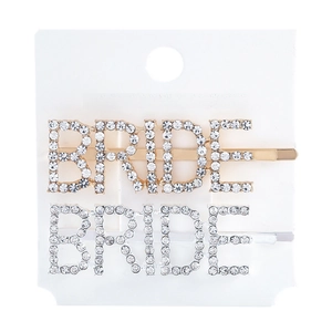 Detail view of gold and silver BRIDE hair clips featuring sparkling rhinestones