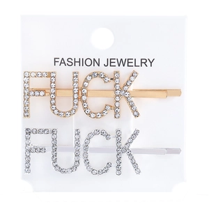 Close-up of gold and silver hair pins with sparkling rhinestone letters on white card
