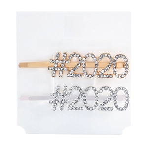 Detail of gold and silver hair clips with rhinestone #2020 design on white display card