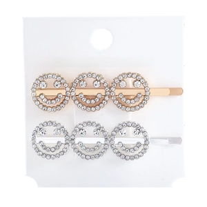 Detail of gold and silver smiley face hair clips with sparkling rhinestones set of two