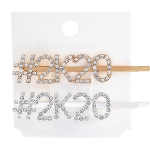Close-up of gold and silver #2K20 hair clips with sparkling rhinestones on card