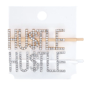 Detailed close-up of gold and silver Hustle hair clips with sparkling crystal rhinestones