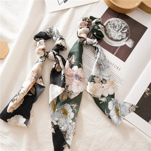 Detail of floral chiffon scrunchies with long streamers in black and dark green prints