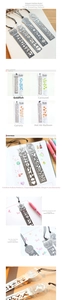 Macro detail of retro hollow metal ruler bookmarks in goldfish and carousel designs