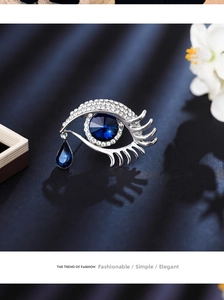 Detailed view of the Angel's Tear eye brooch with blue crystals and sparkling rhinestones