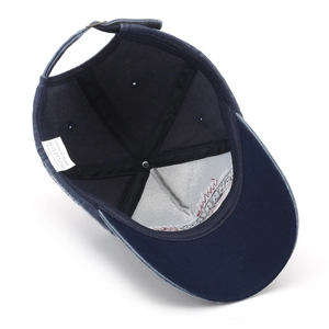 Inside view of navy washed cotton baseball cap showing 100% cotton label and stitching