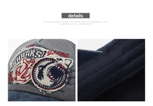 Detail of embroidered shark patch and vintage distressed edges on washed canvas baseball cap